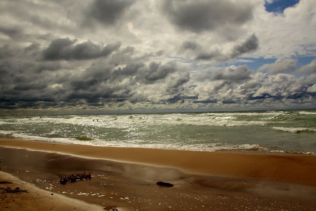 Clouds and light reflecting on Lake Michigan and the beach