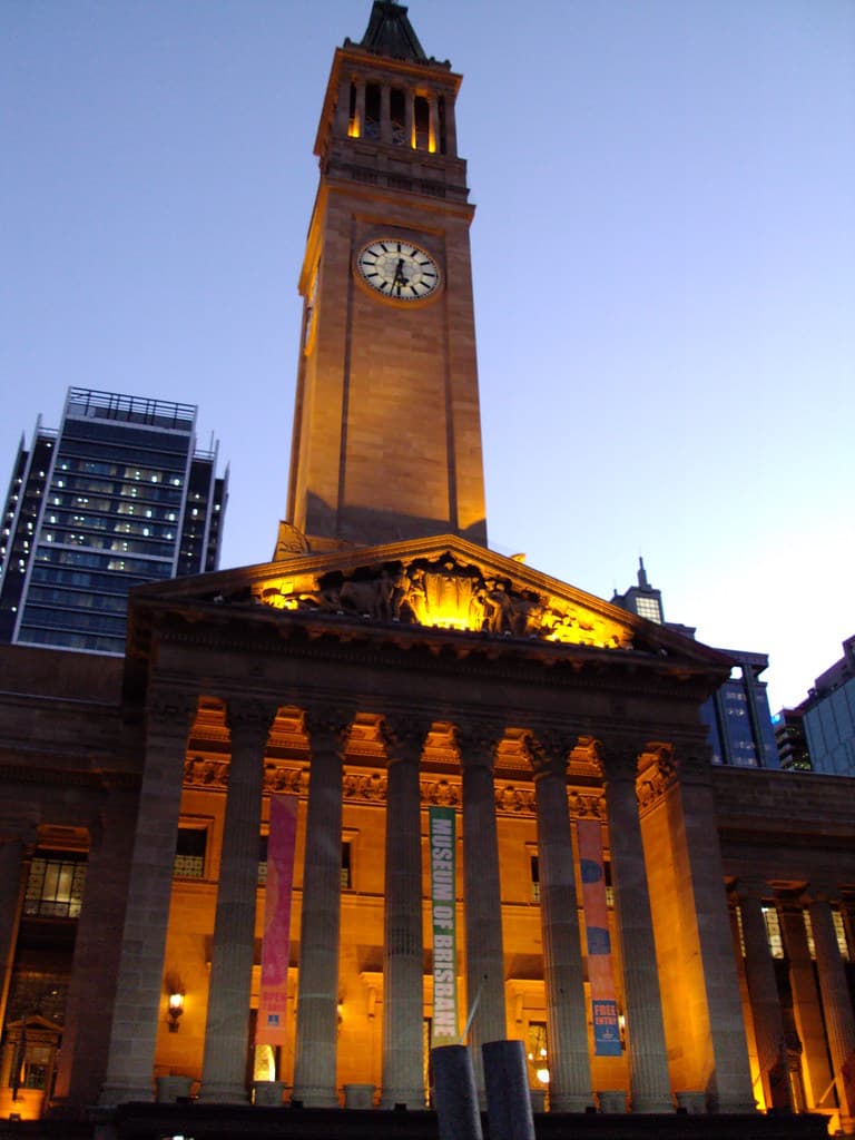 Brisbane Town Hall at dusk. Built 1920 to 1930. Note the tympanum frieze decoration in the triangular pediment above the pillars.