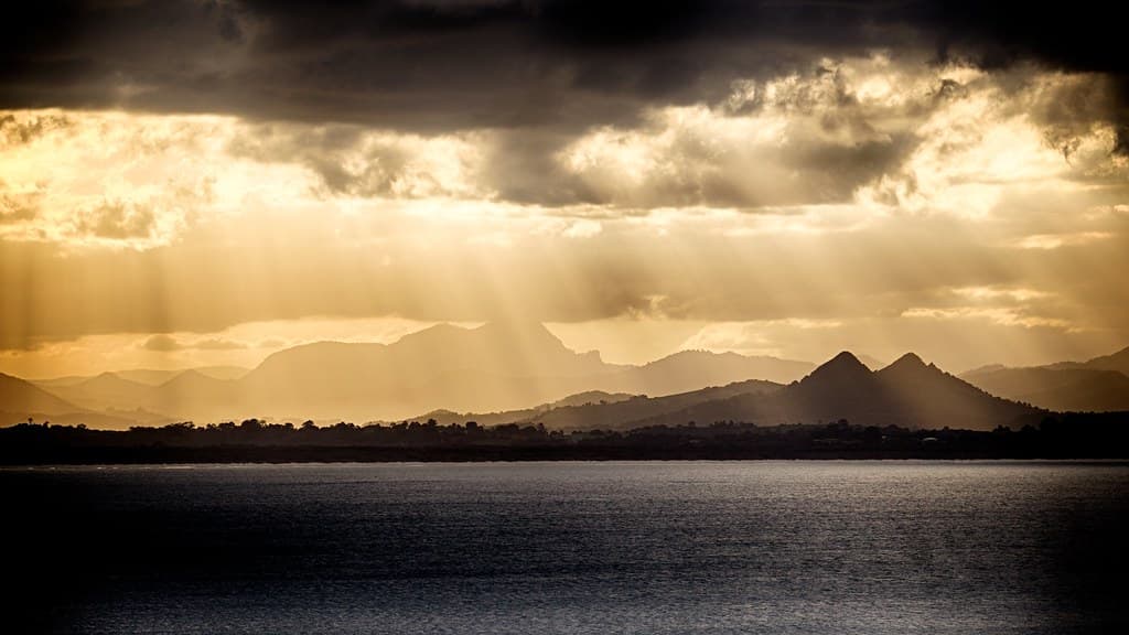 Sunbeams over volcanic mountains