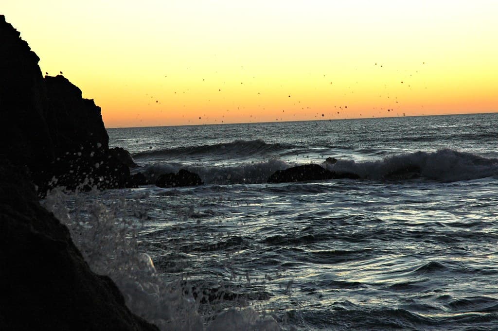 Splash of sea water flys at the edge of the world, gray whale beach, near san francisco, california, usa