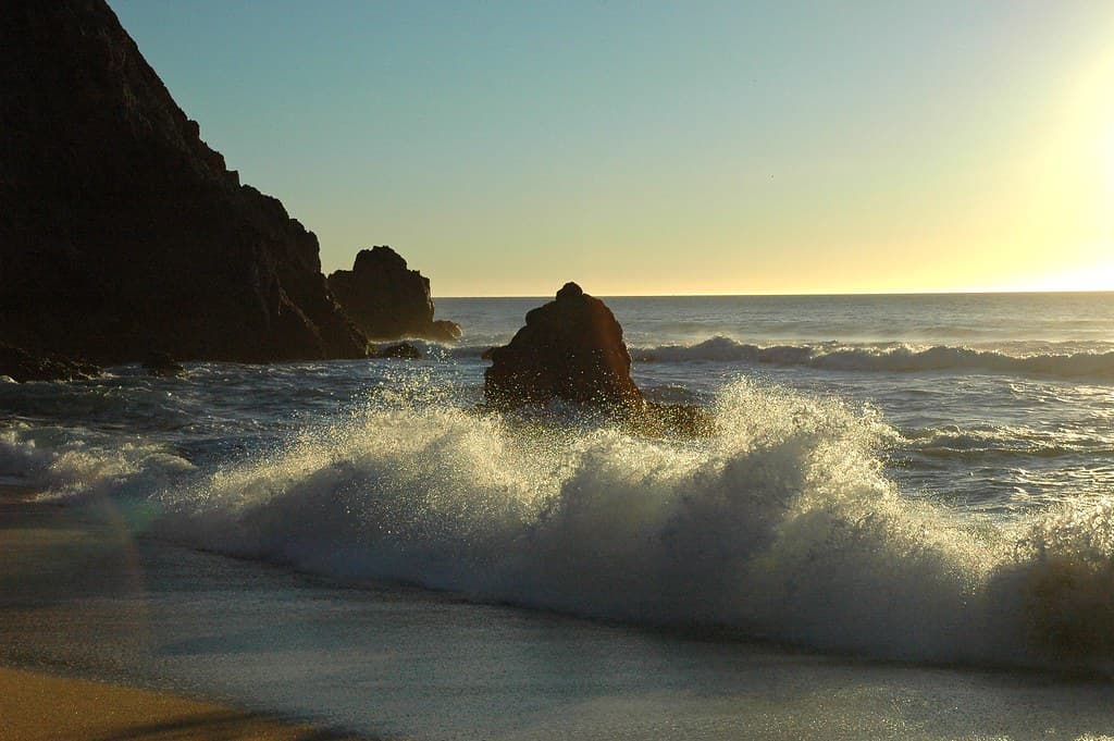 Lively Gray Whale Cove beach - Pacific Ocean south of San Francisco, California, USA