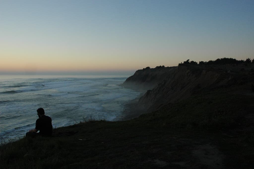 Meditator above Bodhisattva Beach, north of Pillar Point, Pacfic coast of California, USA 9626