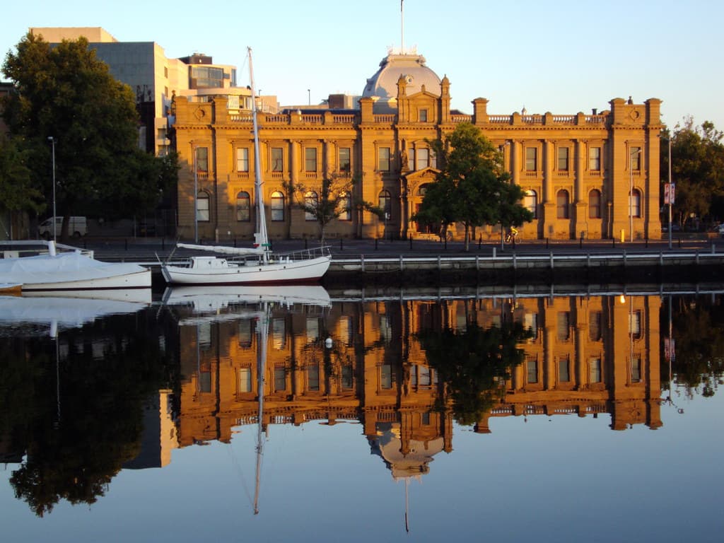 Hobart. Old Customs House reflected in the waters of the docks.