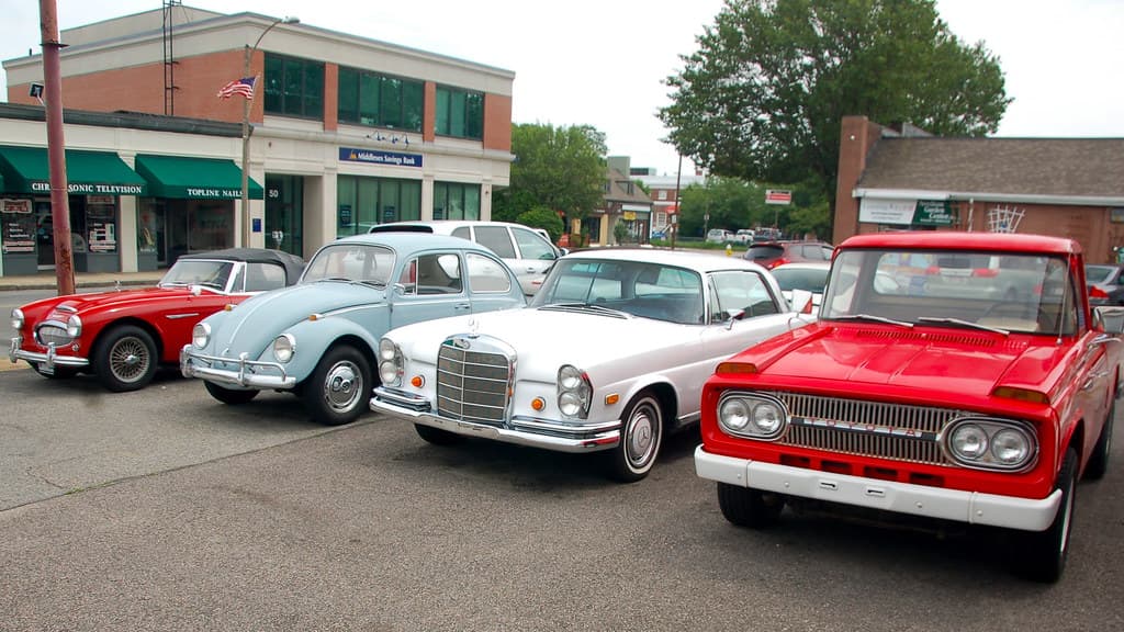 Old cars at Copley Motorcars, Needham MA: 1964 Austin-Healey 3000 MkIII, 1967 Volkswagen Beetle, 1971 Mercedes Benz 280SE 3.5 coupe, and 1966 Toyota Stout