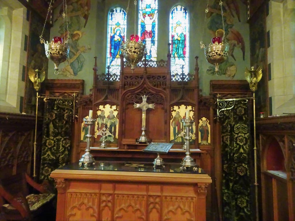 Kapunda in the Light River Valley. The altar of the Anglican church which opened in 1896. Silver and oak carvings all imported from England. The east window is by Powells of London.