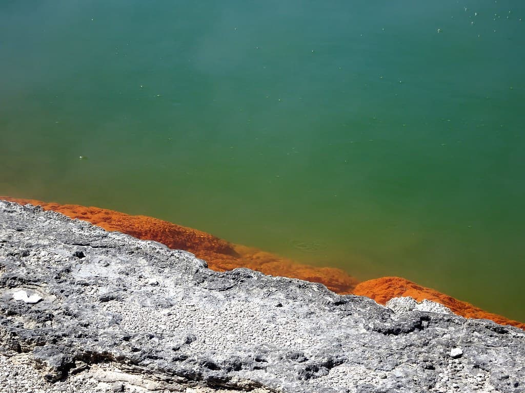Rotorua. The sulphur coloured edge of the Champagne Lake in the geothermal volcanic park of Wai O Tapu.
