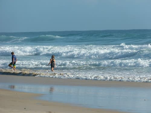 Children at play in waves