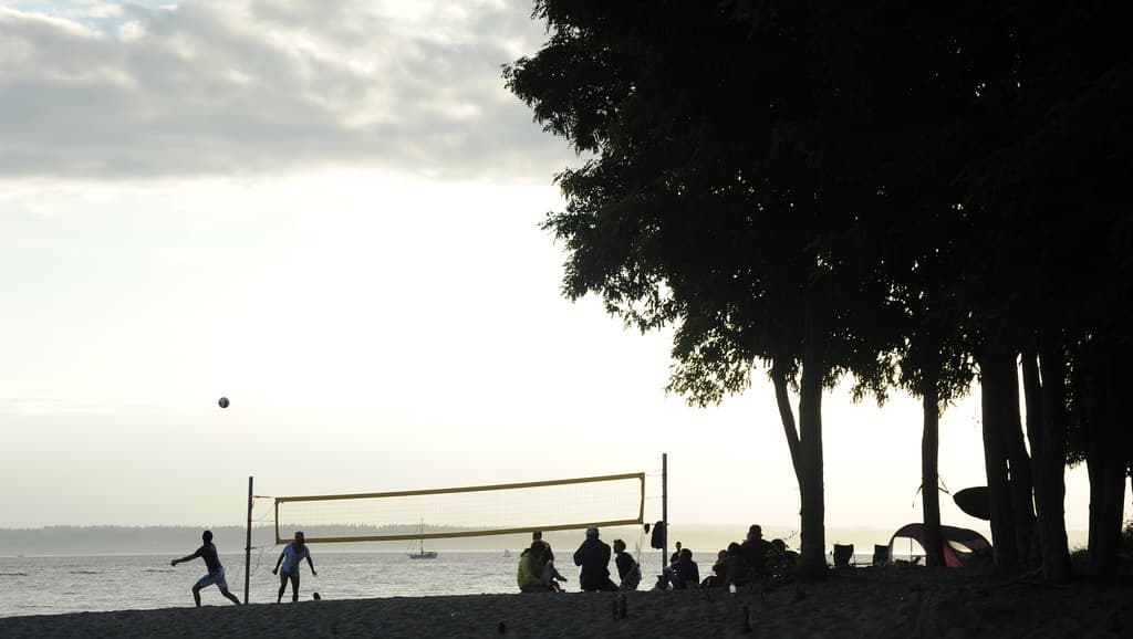 Ball in play, people playing volleyball, net, camping, sailing, summer party on the beach, trees, clouds, mist, Golden Gardens, Seattle, Washington, USA