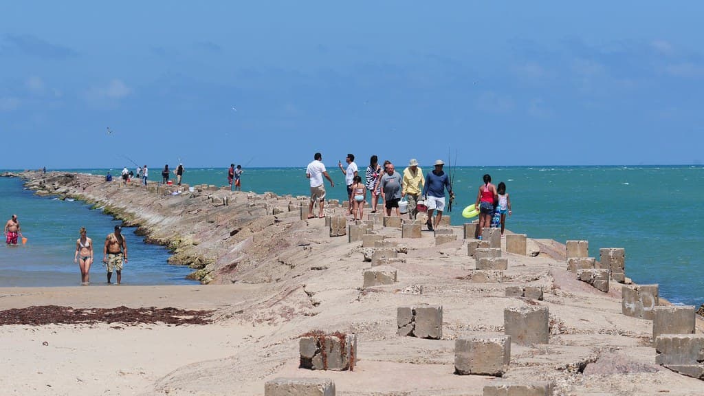 People on breakwater at Isla Blanca Park, South Padre Island, Texas
