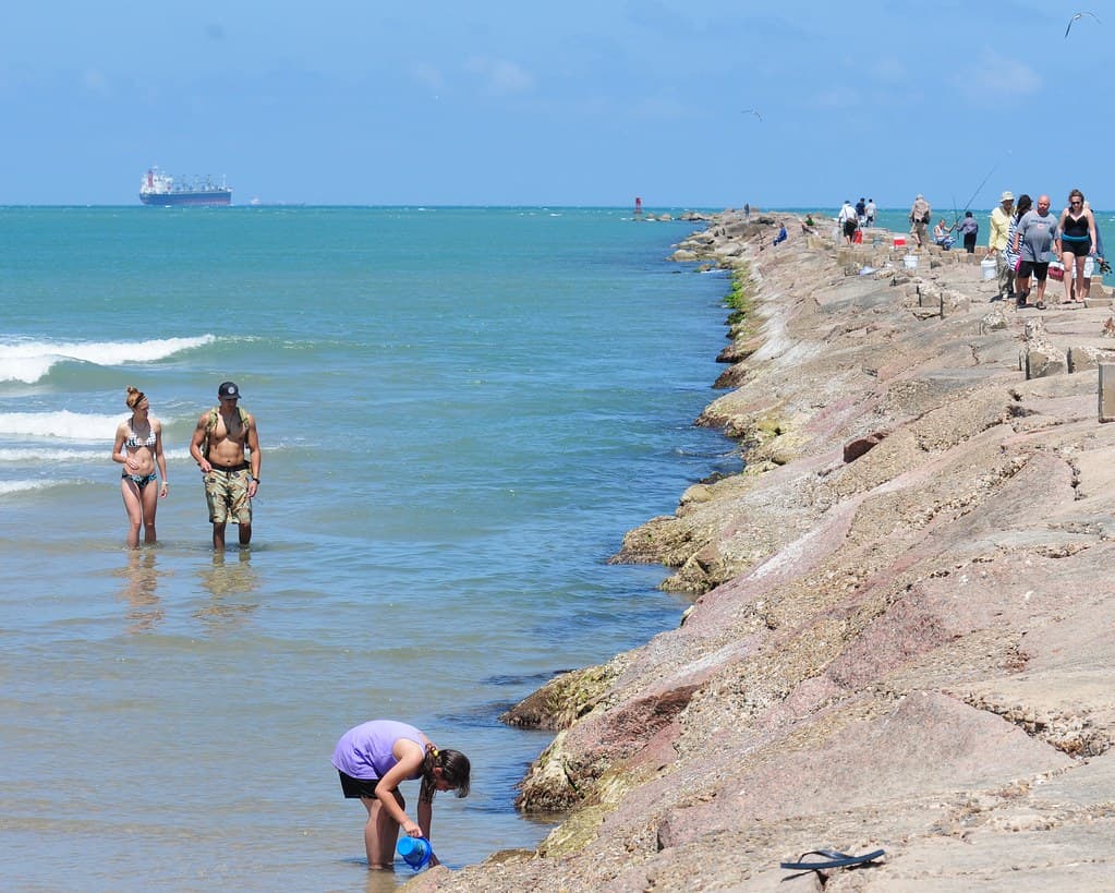 People on breakwater at Isla Blanca Park, South Padre Island, Texas