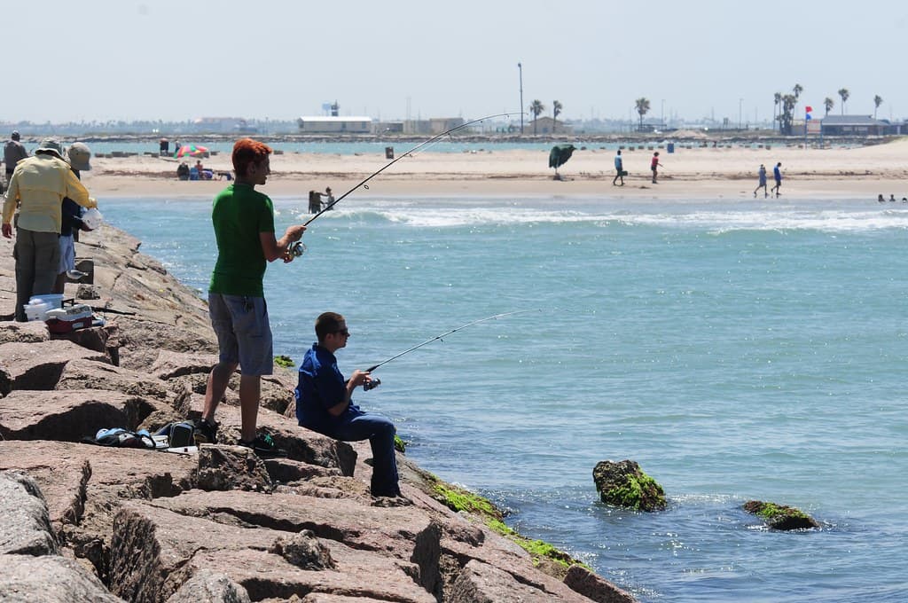 People on breakwater at Isla Blanca Park, South Padre Island, Texas