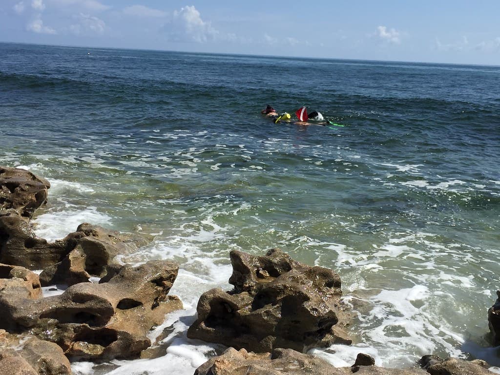 Snorkelers Close to Rocks