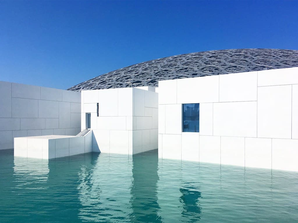 Serene waterscape and architecture of the Louvre Abu Dhabi building, United Arab Emirates, December 2018