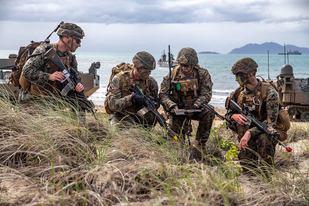 Marines assess a terrain map during a simulated amphibious assault of exercise Talisman Sabre 19