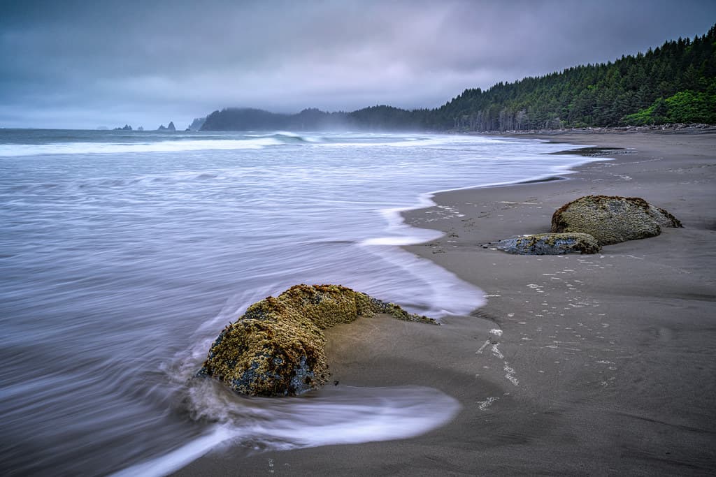 Long exposure of waves hitting rocks  on fog enshrouded Rialto Beach, Olympic National Park, Washington State