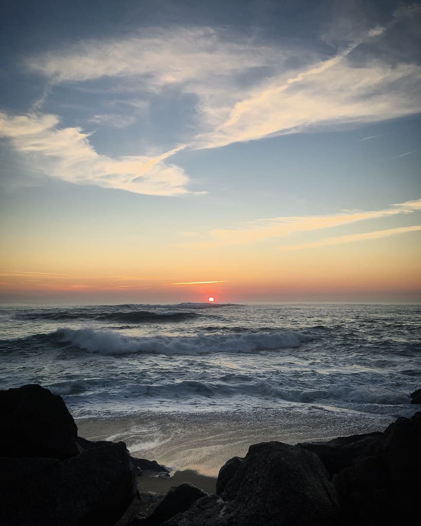 Sunset over the waves of the Atlantic Ocean in Vila do Conde, Portugal, January 2019