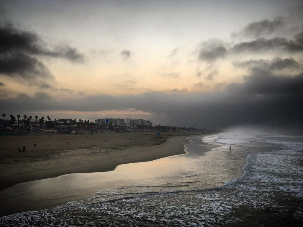 Sunset over the Pacific Ocean coast in Huntington Beach, California, USA, January 2019