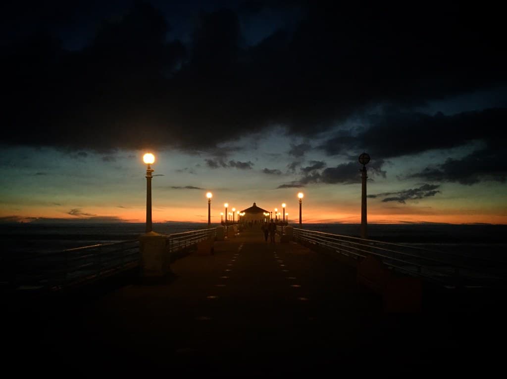Stormy day sunset over the Manhattan Beach Pier on the coast of the Pacific Ocean, California, USA, January 2019