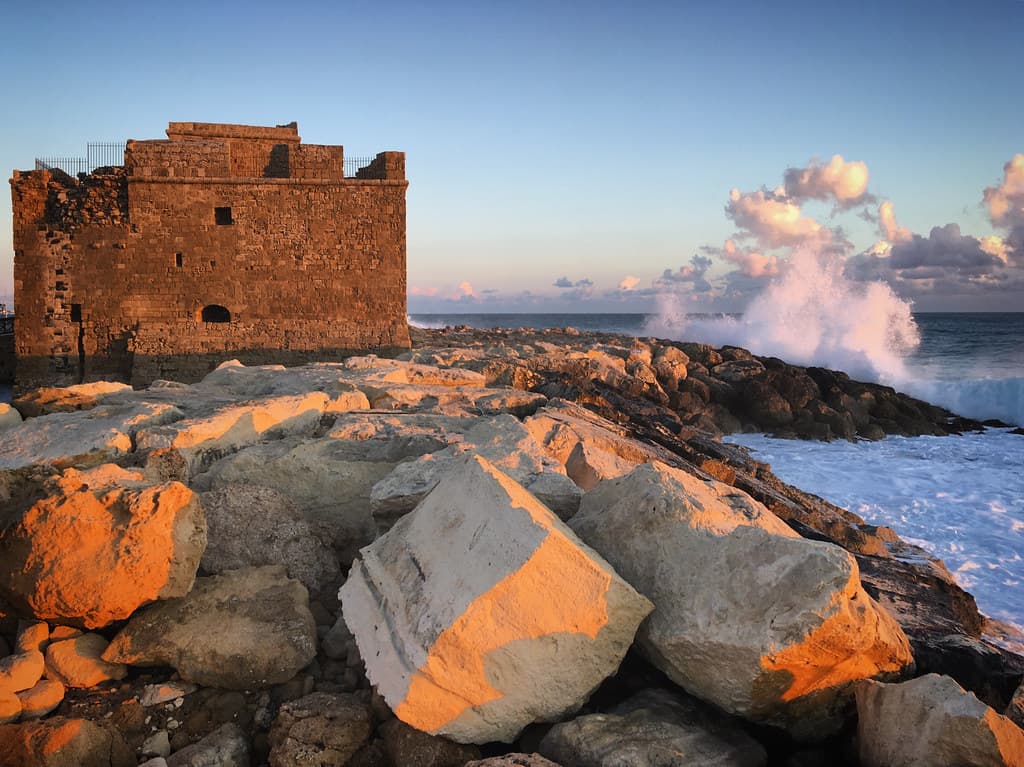 Ruins of the old castle on the coast of the stormy Mediterranean Sea in Paphos, Cyprus, March 2019