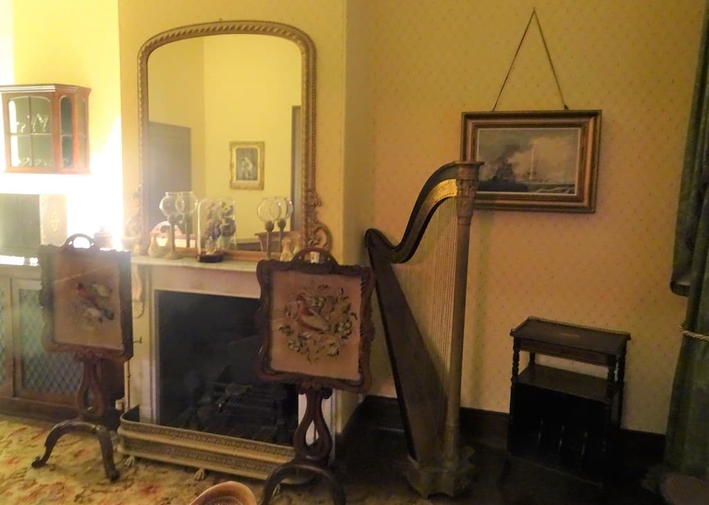 Adelaide. Grange Beach. Explorer Captain Charles Sturt built this grand house in 1840. This is the drawing room next to the dining room. Fire place and pole screens.