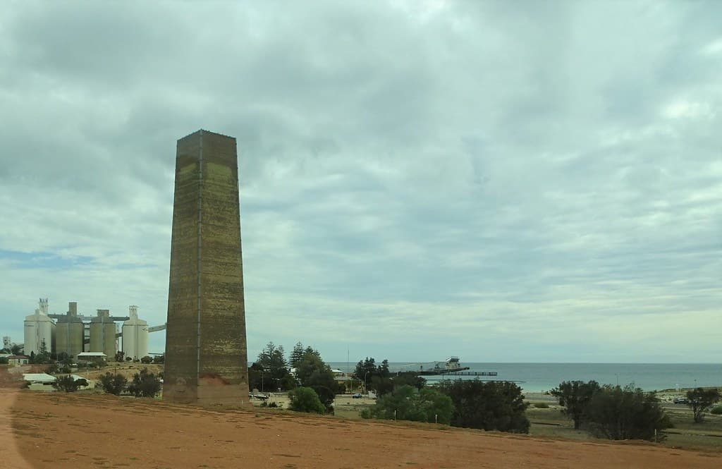 Wallaroo Yorke Peninsula. Wallaroo was the smelting hub for Moonta and Wallaroo copper Mines. Smelters owned by Sir Walter Watson Hughes. This first smelter chimney erected in 1861. There were 13 chimneys at its peak.