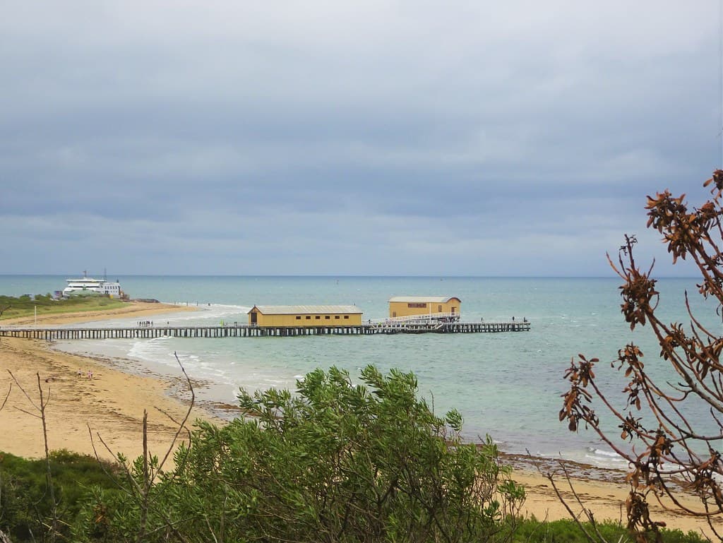 Queenscliffe. Looking across the beach and Port Phillip Bay. The Sorrento ferry is ready for departure to Mornington Peninsula. .