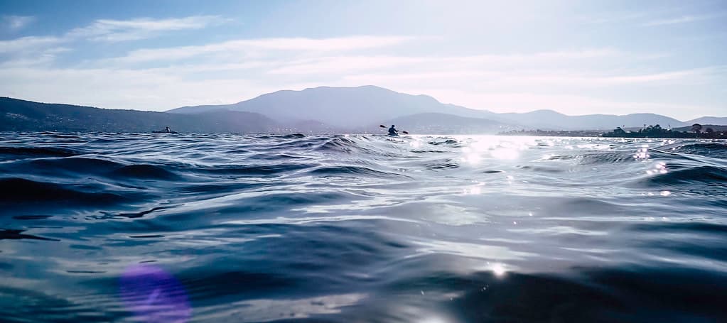 Kayakers with Kunanyi in the background, Little Howrah Beach, Hobart, Tasmania