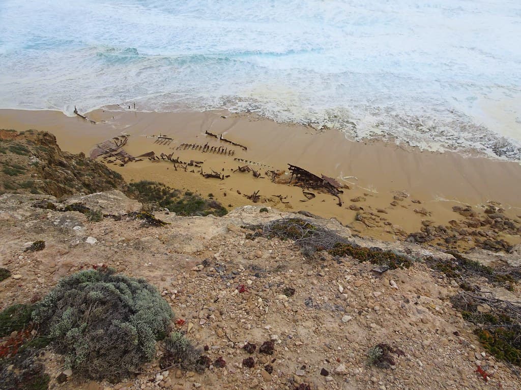 Innes National Park South Australia. An equinoxal gale and rough seas at the wreck of the Ethel beach. Some of the iron wreckage of the 1904 wreck is still on the sand.