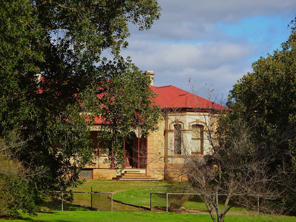 Salter Springs. SA. Farmer  Robert Smyth built a grand home with bay windows (1879). He planted two Moreton Bay Figs in the garden. Monte Flora House has  Kapunda cast iron lacework