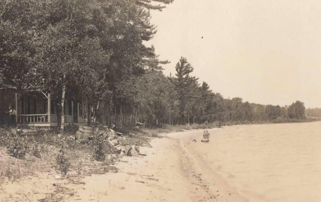 NW Northport Omena MI RPPC c.1910 RARE INDIAN BEACH CLUB HOUSE Great Porch looking on on to the Bay & from 1932 until 1945 this area was home to CAMP SHADY TRAILS Grand Traverse Region Photographer HERBERT 1-2