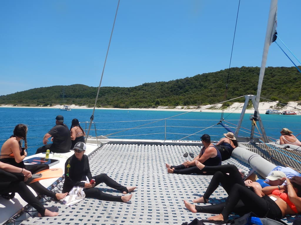 Relaxing on the catamaran, approaching Chalkies Beach on Haslewood Island