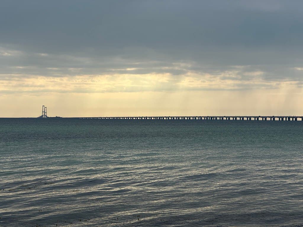The Great Belt Bridge over the Storebælt strait under the stormy sunrise sky, Nyborg, Southern Denmark, June 2023