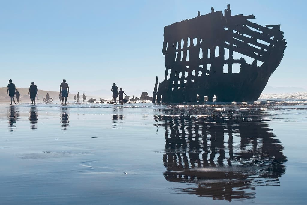 Morning beachgoers at the historic Wreck of the Peter Iredale - Hammond, Oregon