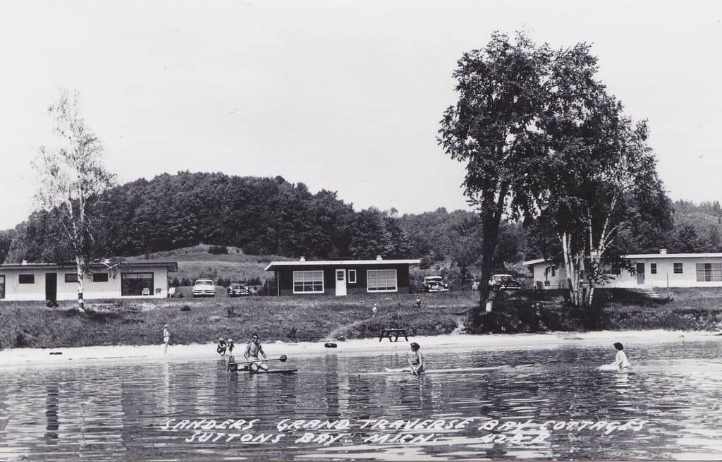 NW Suttons Bay Leelanau MI c.1950 RPPC M-22's SANDERS RESORT COTTAGES Warm Water Warm Breezes Sandy Beaches Fun Times in the Family Vacation Era on GT Bay Your Host George Sanders Owner Proprietor