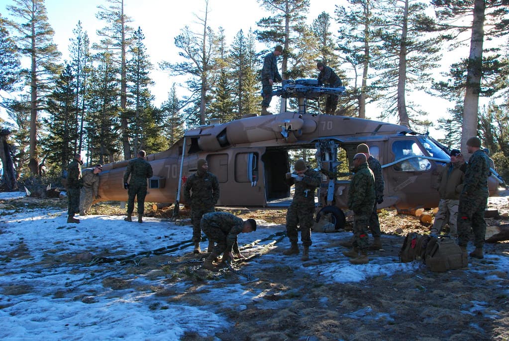California Army National Guard Chinook crew works with multi-service recovery team to slingload a downed Navy helicopter from high mountain training area