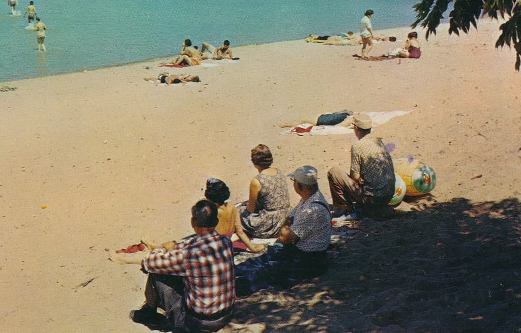 CEN Port Austin MI 1950s BEACH BABES & Vacationing Tourist Familys Port Austin Harbor & Beach Swimming Pier near Port Crescent State Park on Lake Huron Photographer Unknown Postmarked 19602