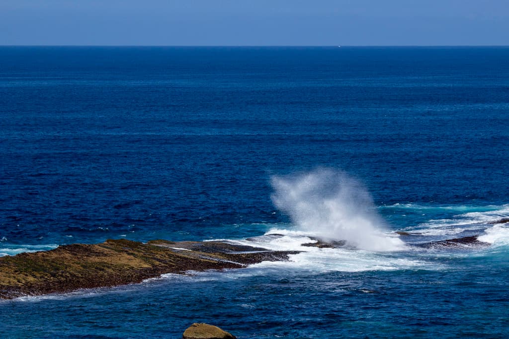 Waves crashing on rocks, Ulladulla's south headland, AU
