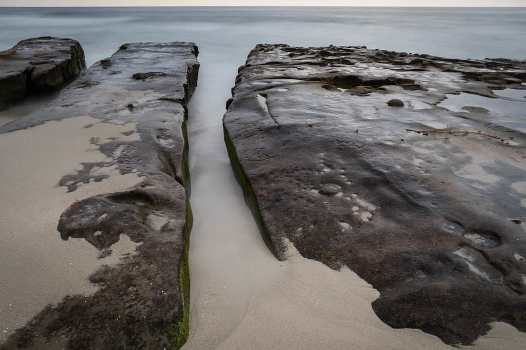 Sand Meets Rock and Water