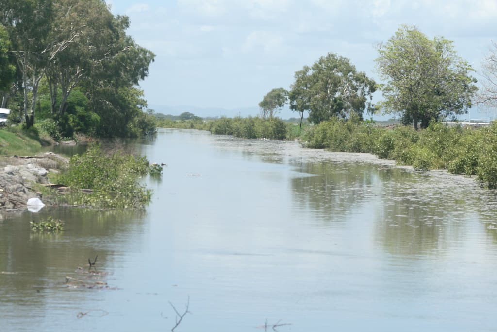 Drain Bridge Road Mackay near Illawong Beach East Mackay  Bridge Road is a major road & runs east west from Illawong Beach through Sth Mky to West Mky. Water in photo is from high tide as Mky has had very little rain, well below the Jan average