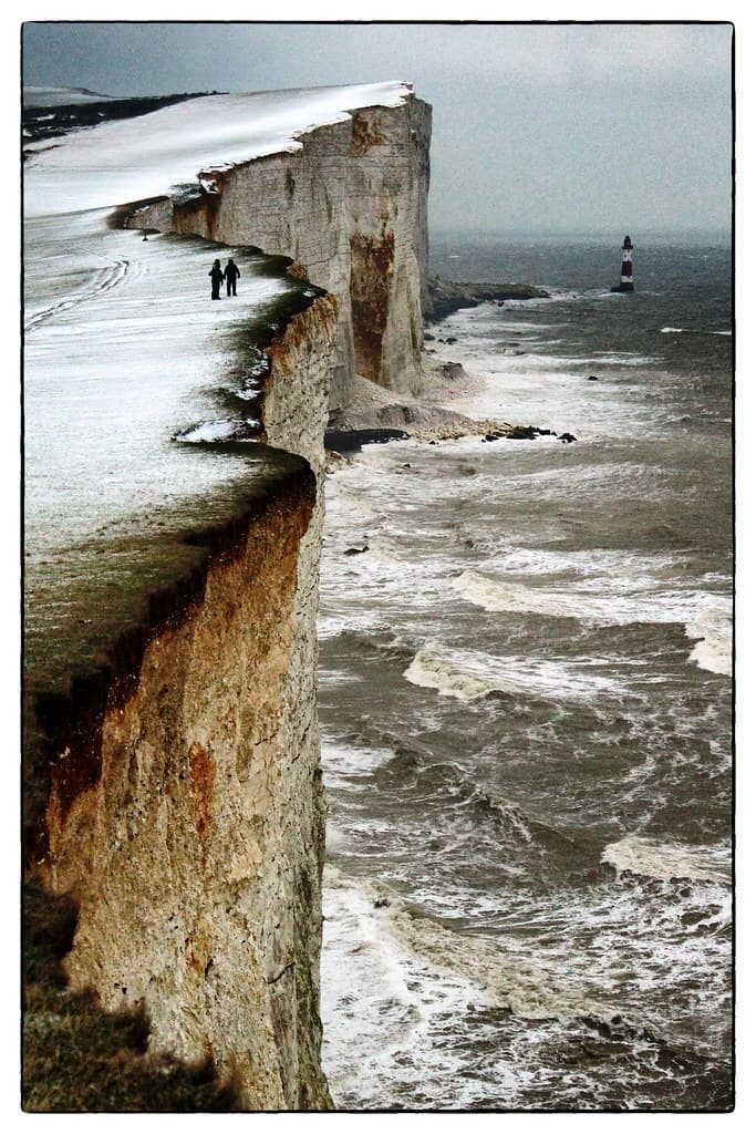 Walkers on Snowy Cliff Top