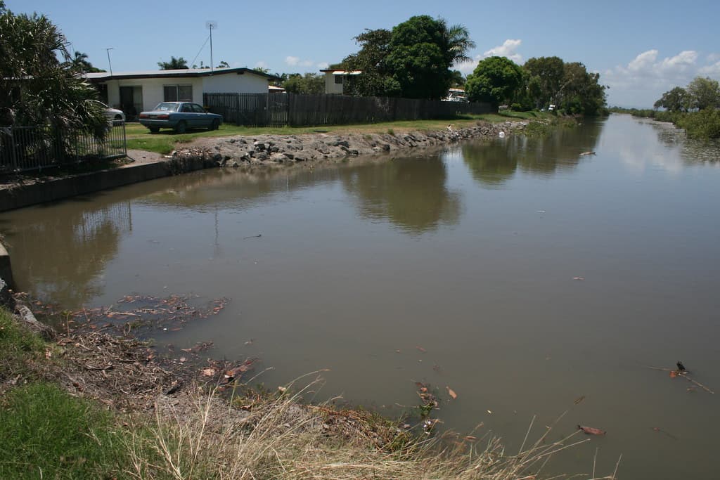 Drain Bridge Road Mackay near Illawong Beach East Mackay  Bridge Road is a major road & runs east west from Illawong Beach through Sth Mky to West Mky. Water in photo is from high tide as Mky has had very little rain, well below the Jan average