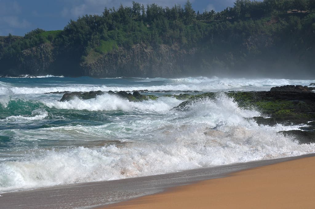 Secret Beach, Northern Kauai with Winter waves from Japan. Kauapea Beach.