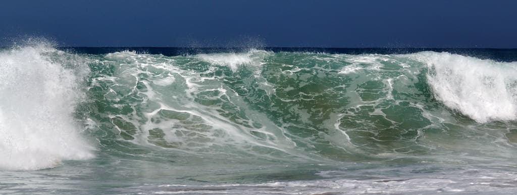Secret Beach, Northern Kauai with Winter waves from Japan. Kauapea Beach.