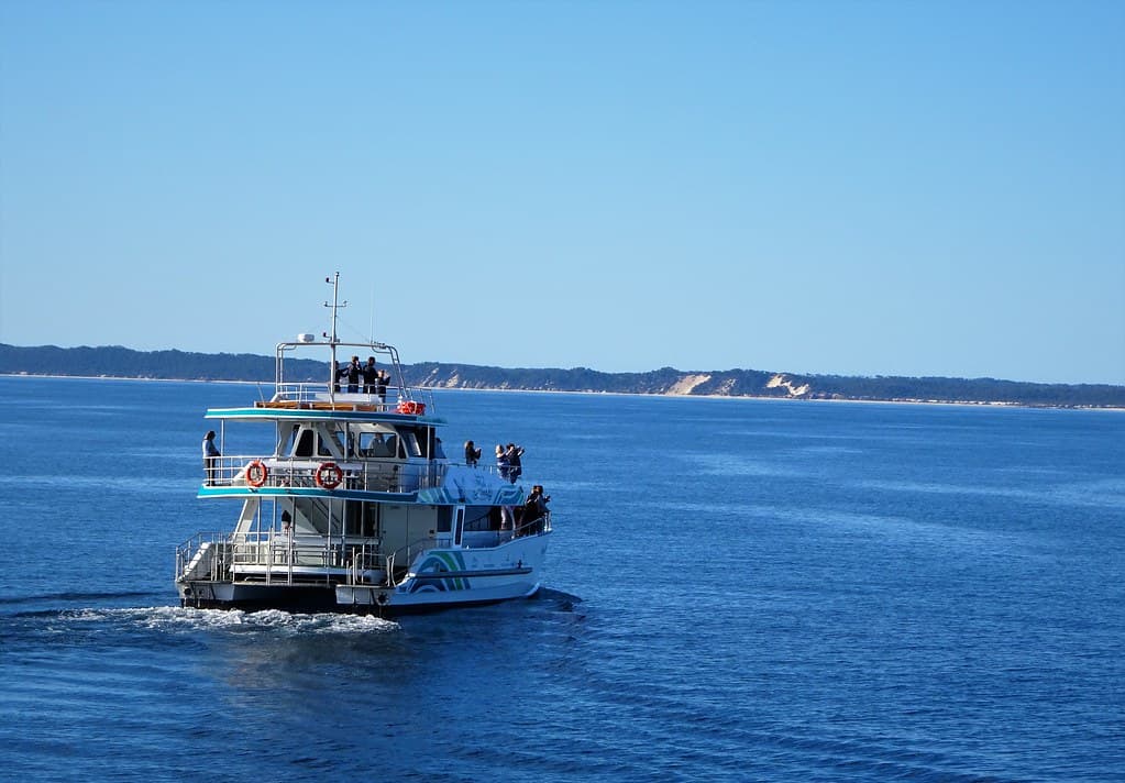 Hervey Bay with Fraser Island in the background. Whale watching boat in July.